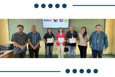 Six adults pose with certificates in a classroom during an award ceremony, banner visible in the back.