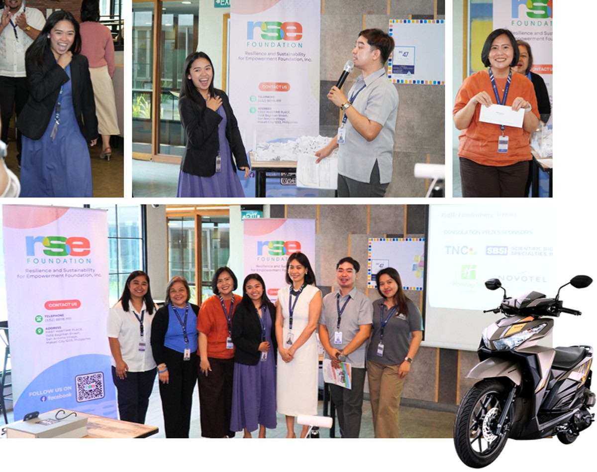Group of event attendees posing for a photo in front of RSE Foundation banners and a motorcycle on display in the corner.