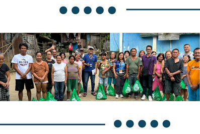 Diverse group of people standing in a row outdoors, each holding a green bag of supplies.
