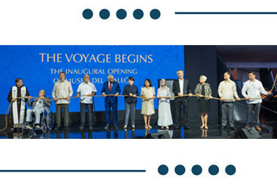 Group of people on stage cutting a ceremonial ribbon at the inaugural opening, banner reads 'The Voyage Begins'.
